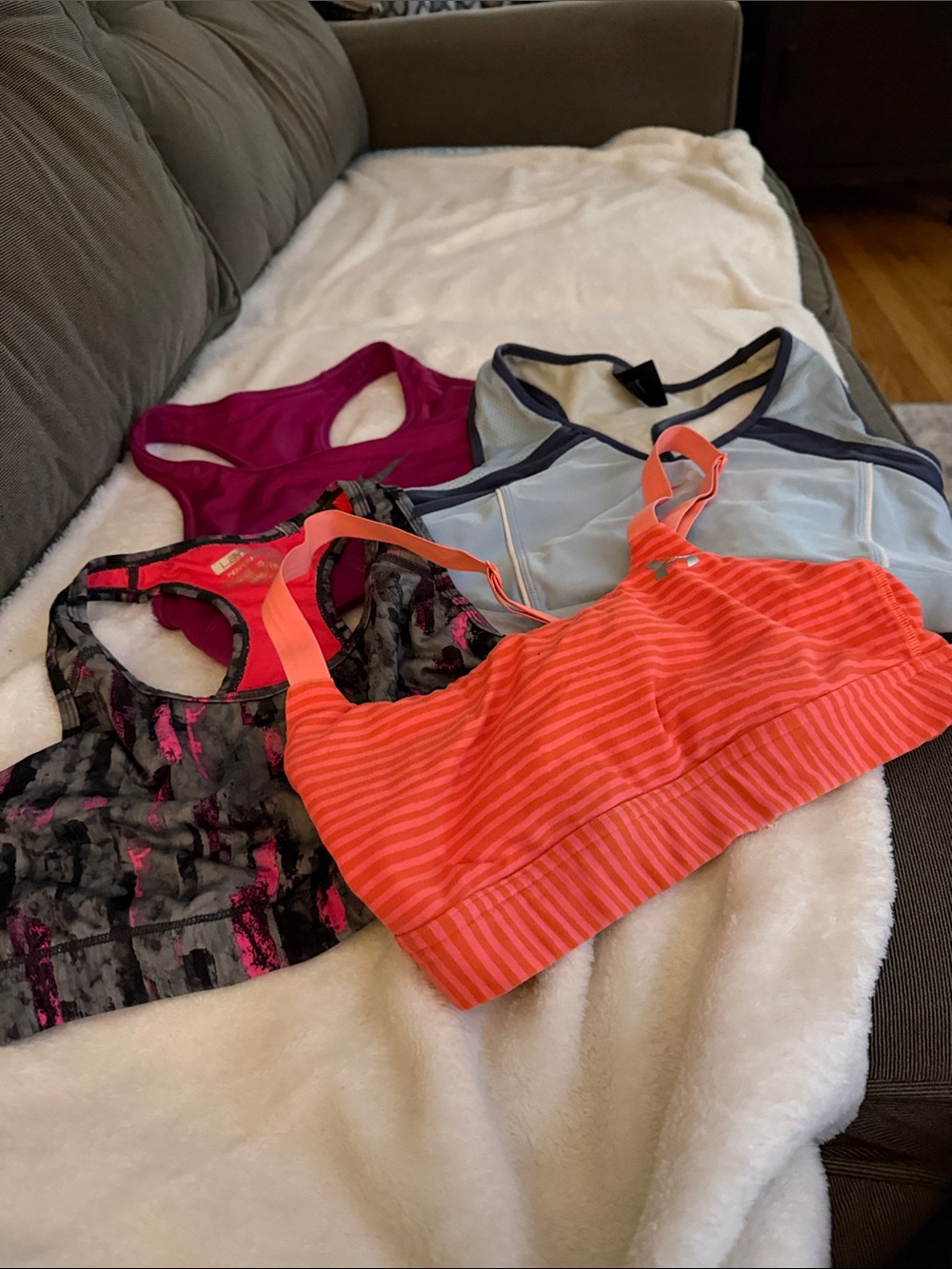 4 sports bras. 2 Nike 1 Under Armor 1 Layer8